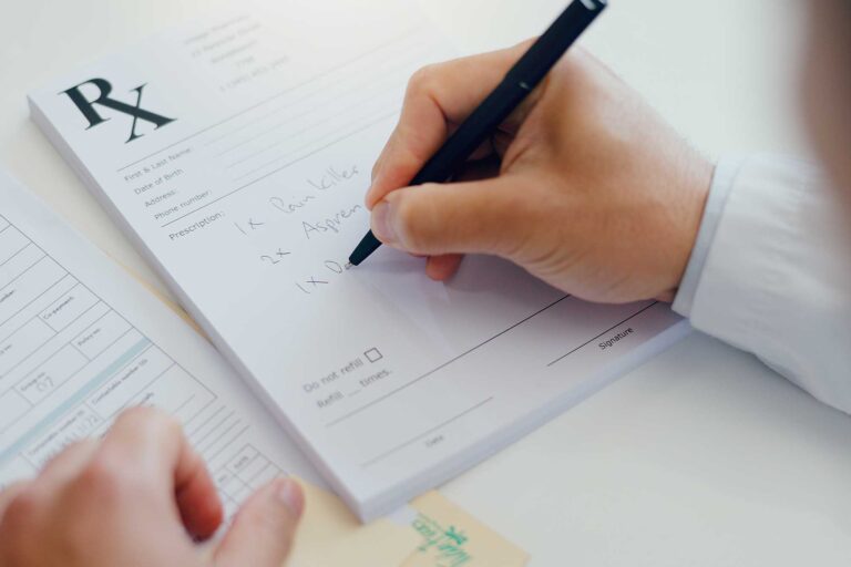 Doctor writing prescription for medication management | Healnex