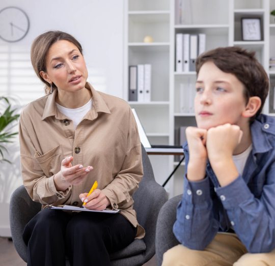 Pensive teenage guy at an appointment with a female psychologist | Healnex